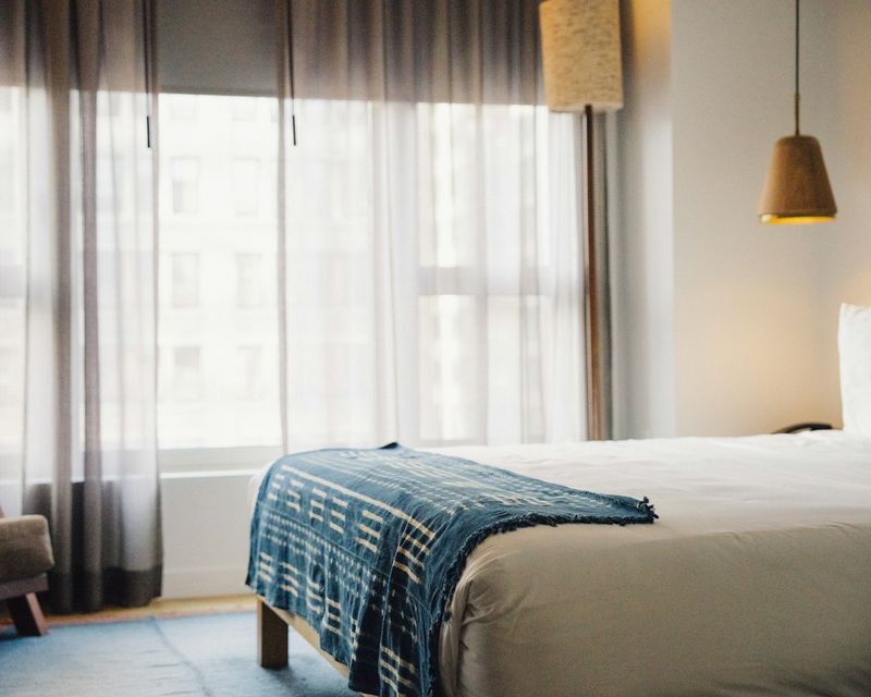 Bright hotel room with a double bed